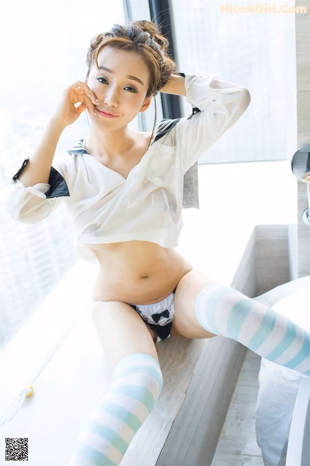 A woman in a white shirt and blue and green striped stockings.