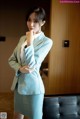 A woman in a blue suit posing for a picture.