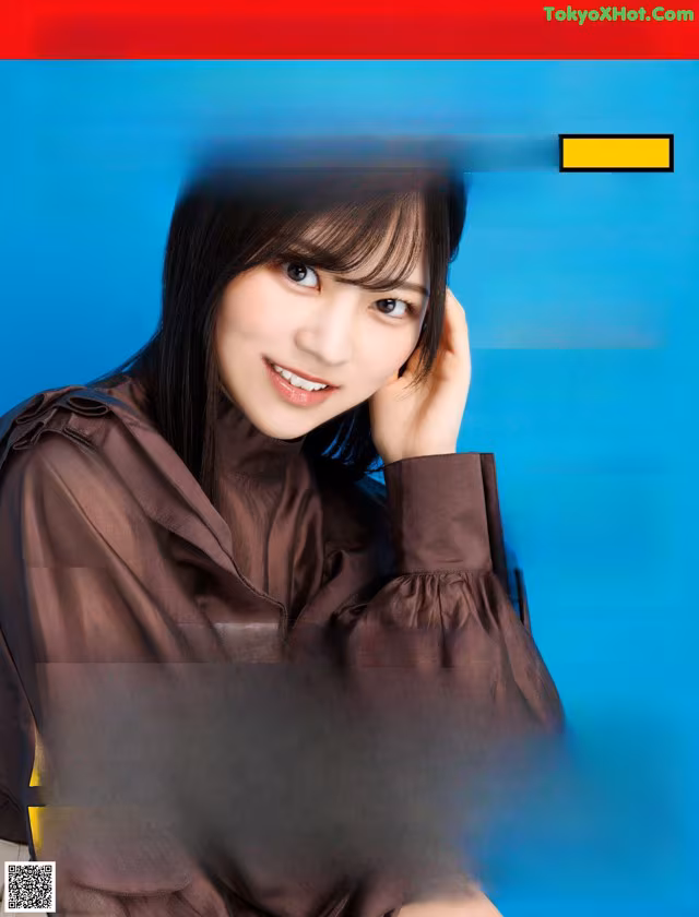 A woman in a brown shirt is posing for a picture.