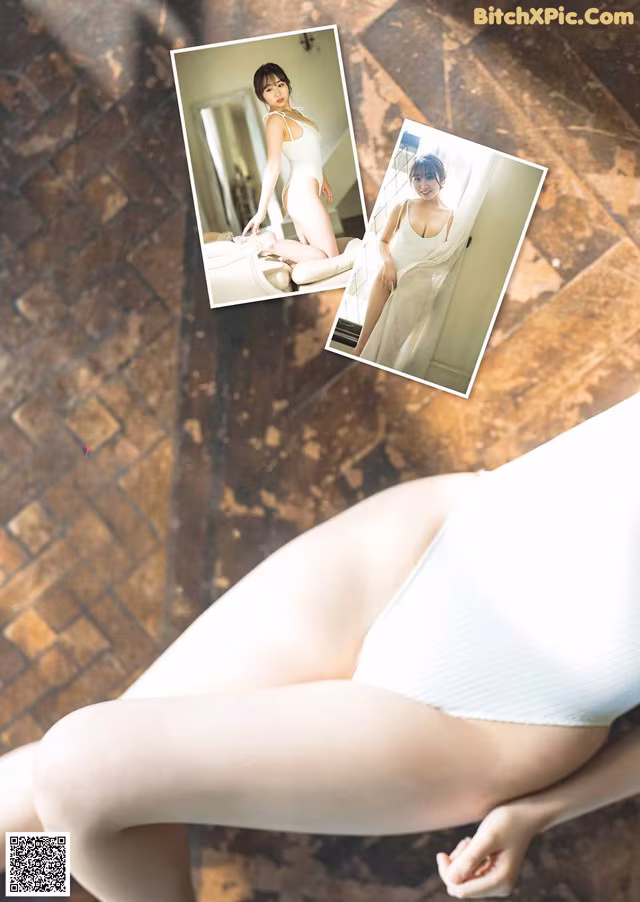 A woman in a white bodysuit sitting on the floor.