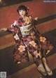 A woman in a kimono is posing for a picture.